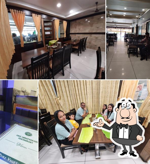 Take a seat at one of the tables at Sri Annapoorani Veg Restaurant