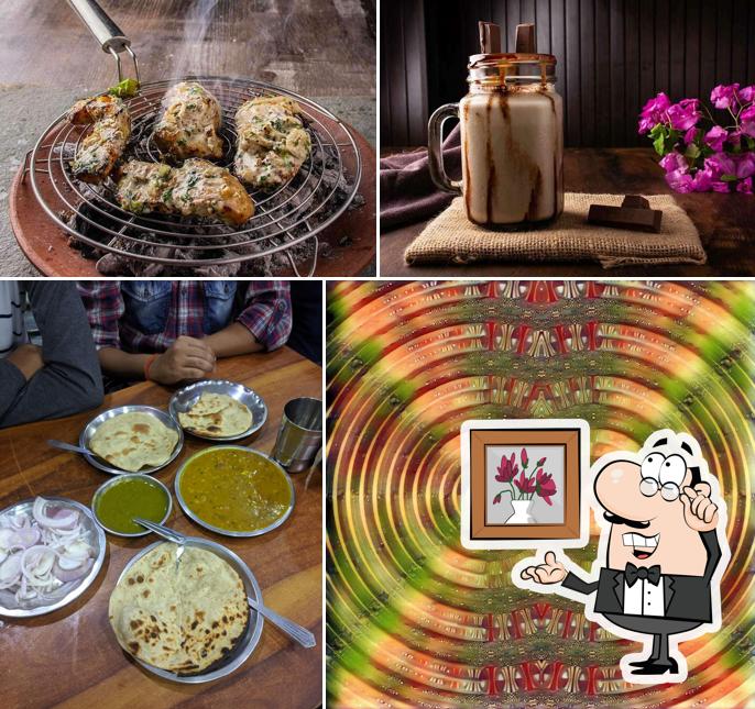 Take a seat at one of the tables at Happy Punjabi Shudh Vaishno Dhaba