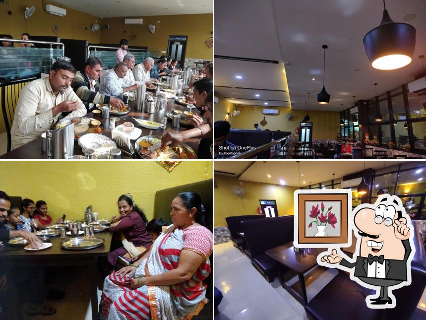 Take a seat at one of the tables at Real Kathiyavadi Restaurant - Best Kathiyawadi Restaurant