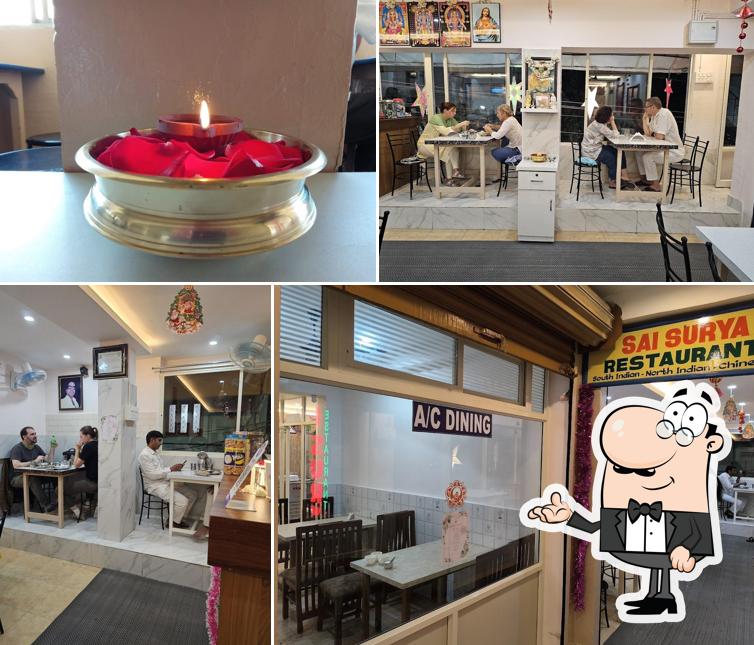 Take a seat at one of the tables at Sai Surya Restaurant