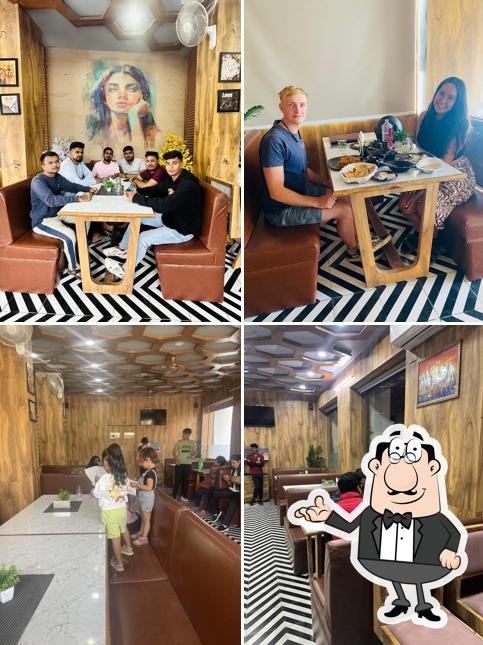 Take a seat at one of the tables at Kamal restaurant and dining hall ( Pure veg. )