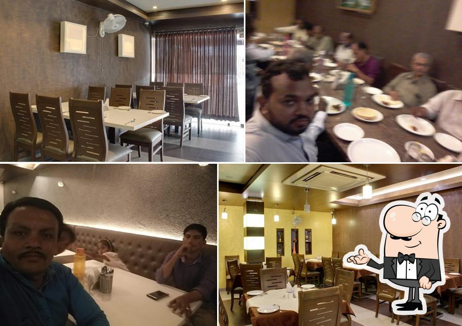 Take a seat at one of the tables at Navjivan Restaurant