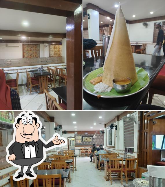 Take a seat at one of the tables at HOTEL UDUPI (PURE VEG)