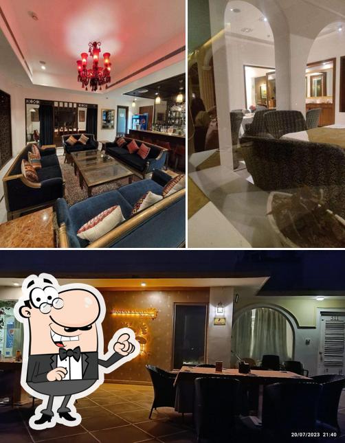 Take a seat at one of the tables at Brahma Kamal Restaurant