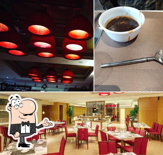 Take a seat at one of the tables at ASTER - MULTI-CUISINE RESTAURANT