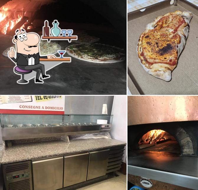 Questa è la immagine che raffigura la interni e cibo di Punto pizza