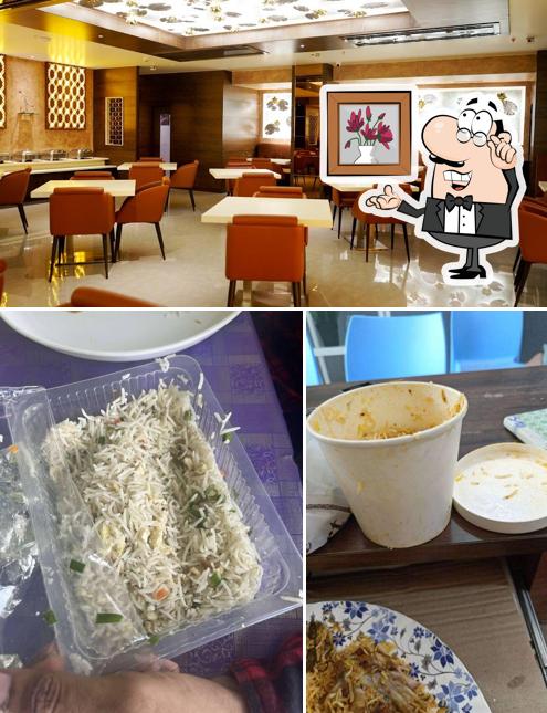 Take a seat at one of the tables at New Satyam Multicuisine Restaurant