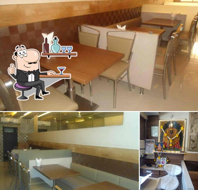 Take a seat at one of the tables at Tiranga Camp Veg & Nonveg Restaurant
