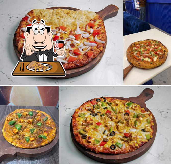 Try out pizza at Gup shup house
