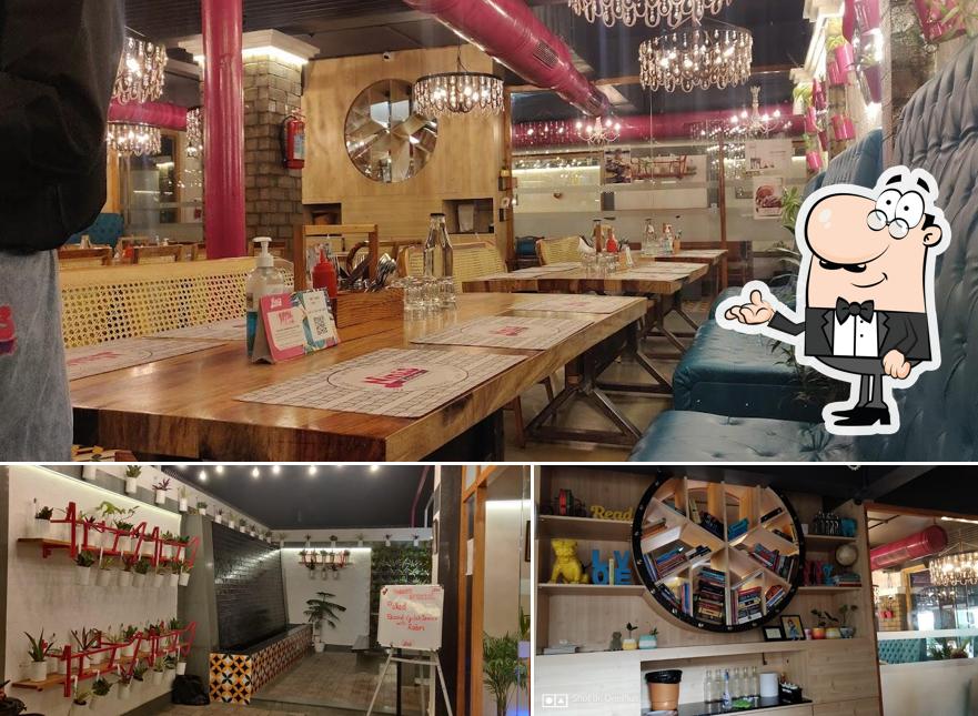 Take a seat at one of the tables at Nini's Kitchen - (V V Nagar)