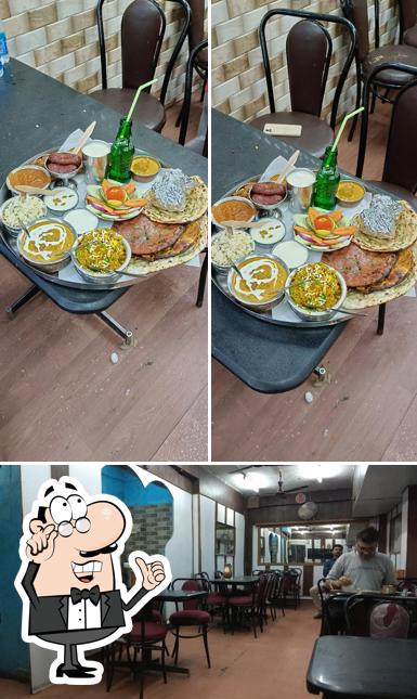 Take a seat at one of the tables at Punjabi Pure Veg Restaurant(since 1994)