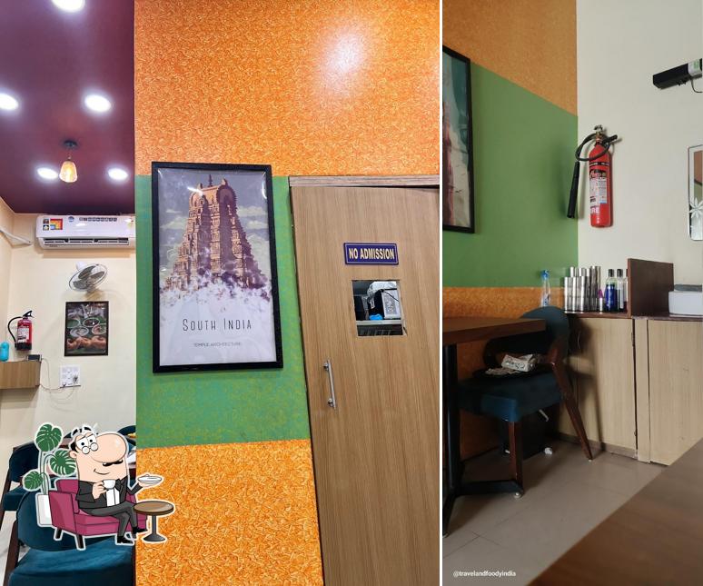 Take a seat at one of the tables at Karnataka Cafe