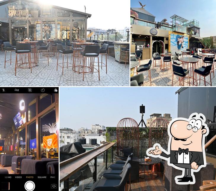 Take a seat at one of the tables at The Sky Story Luxury Lounge - Rooftop Glasshouse Skydine Cafe