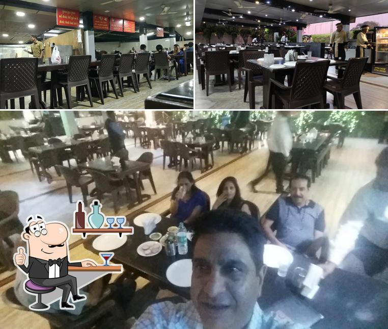 Take a seat at one of the tables at Hotel Sheetal Family Restaurant (Veg /Non-Veg)