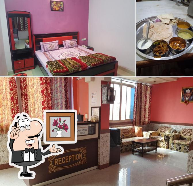 Take a seat at one of the tables at Hotel Bhavya Mansion