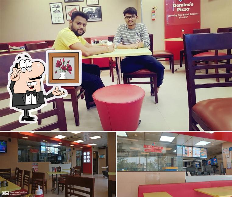 Take a seat at one of the tables at Domino's Pizza Nana Varachha, Surat