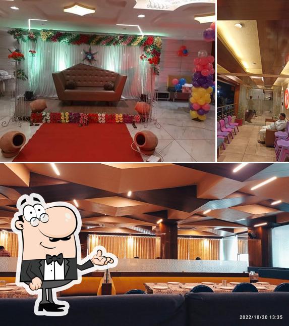 Take a seat at one of the tables at Mayur Restaurant & Banquet