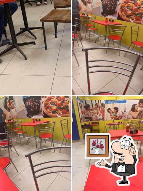 Take a seat at one of the tables at Domino's Pizza 4D Square Mall, Ahmedabad