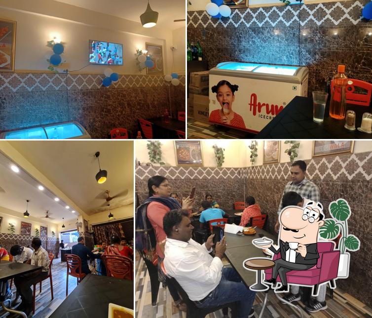 Take a seat at one of the tables at Veg wala restaurant