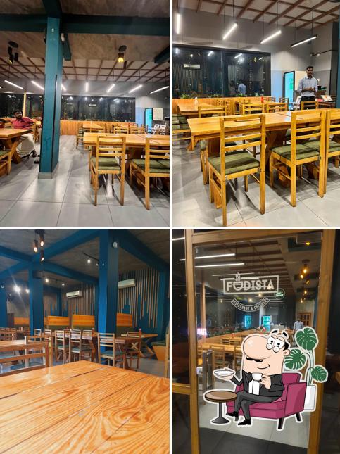 Take a seat at one of the tables at FUDISTA RESTAURANT