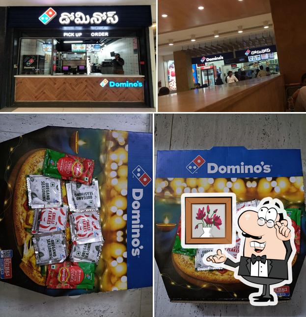 This is the image displaying interior and food at Domino's Pizza PVP Mall, Vijayawada