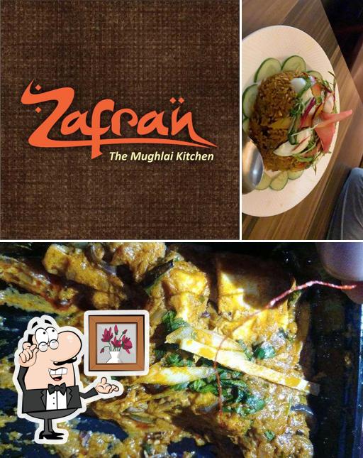 Check out the picture showing interior and food at Zafran