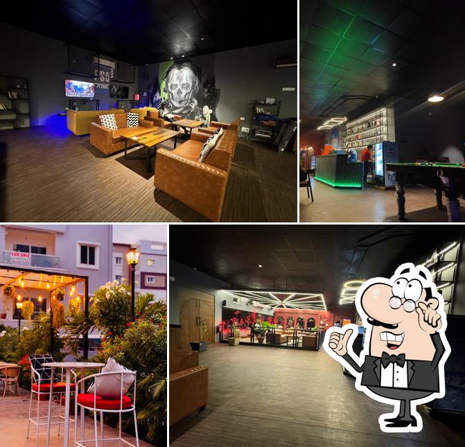 Take a seat at one of the tables at Cafe Game Theory - Restaurant, Gaming Zone, Private Theatres & Party Events