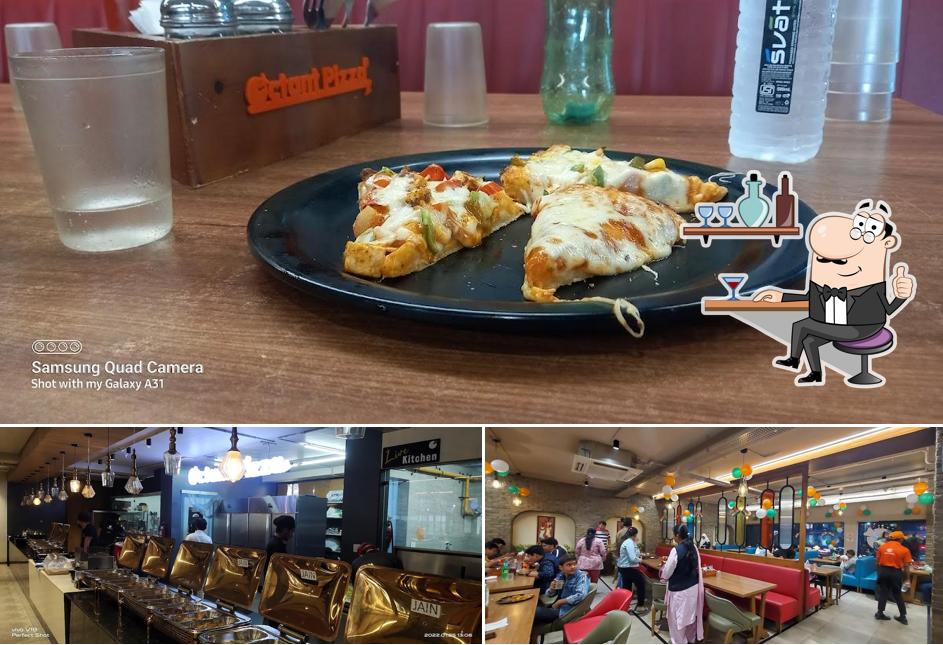 Take a seat at one of the tables at Octant Pizza, CG Road - Ahmedabad