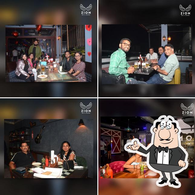 Take a seat at one of the tables at Zion Bar And Lounge