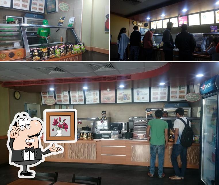 Take a seat at one of the tables at Subway Patel Colony