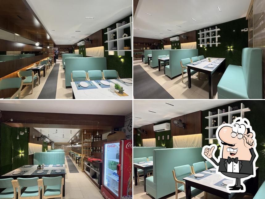 Take a seat at one of the tables at Abhi's Grillland & Sizzlly Chicken Family Restaurant