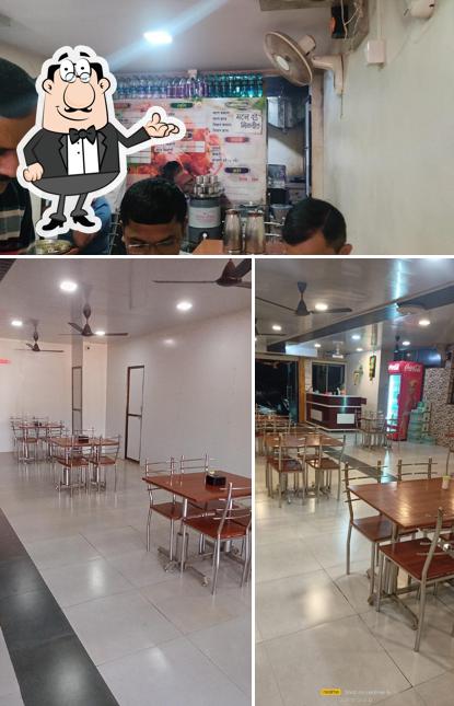 Take a seat at one of the tables at Hotel Sai Sparsh Dapoli