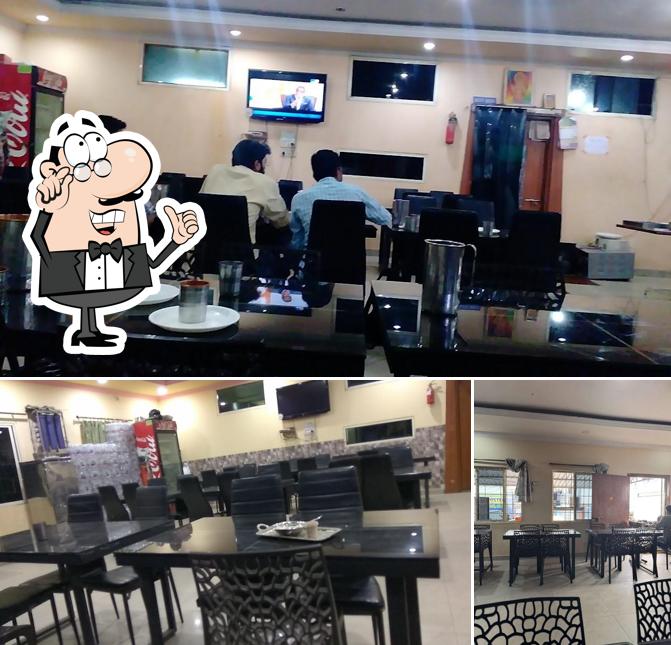 Take a seat at one of the tables at Hotel Samskruthi