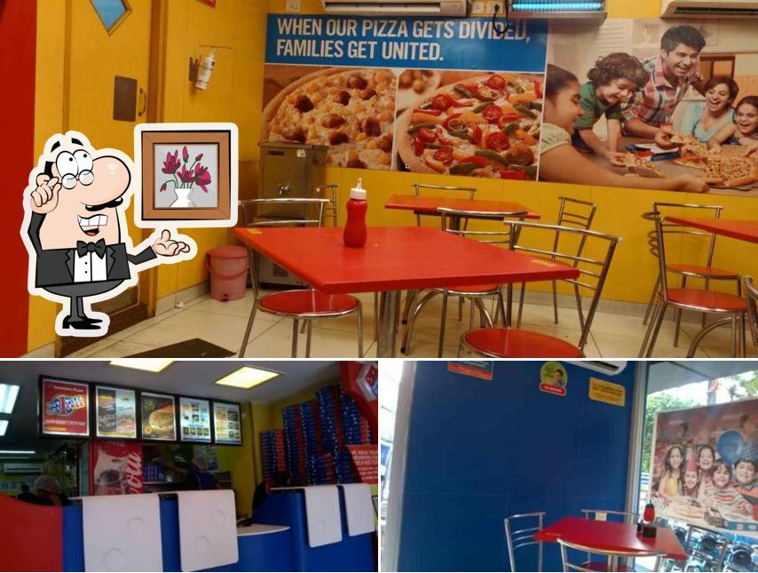 Take a seat at one of the tables at Domino's Pizza