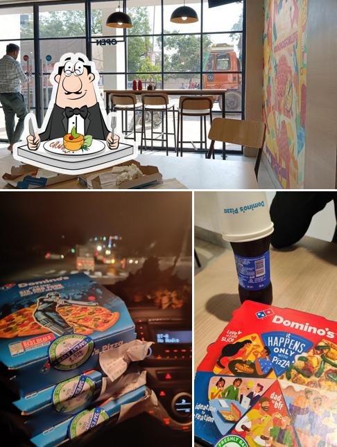 This is the photo showing food and interior at Domino's Pizza Paras Chouraha, Hiran Magri