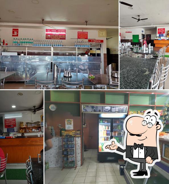 Take a seat at one of the tables at Hotel Kongu (Classic) A/C