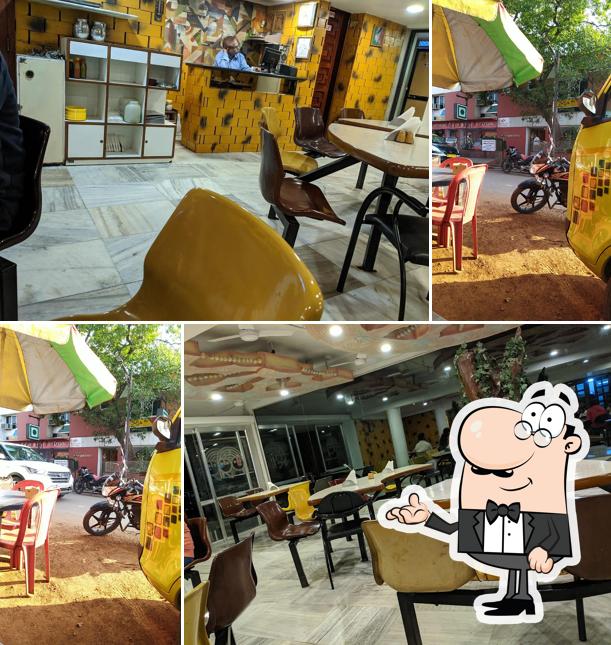 Take a seat at one of the tables at Panorama Veg Restaurant