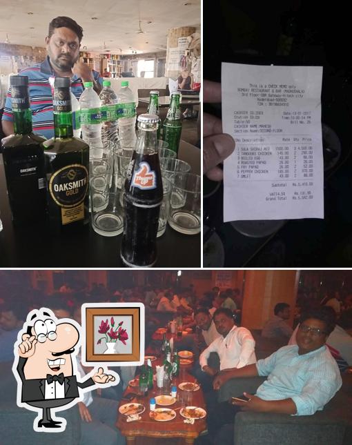 Take a seat at one of the tables at Madhushala Bar