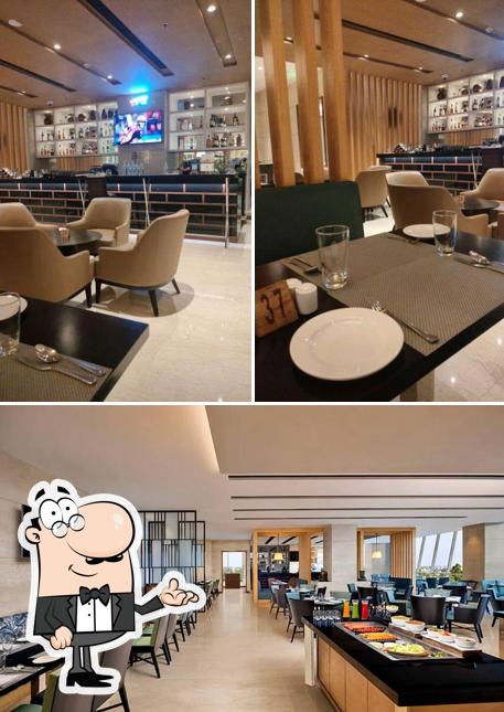 Take a seat at one of the tables at Cosmos Cafe & Bar - Fairfield By Marriott Take a seat at one of the tables at Cosmos Cafe & Bar - Fairfield By Marriott