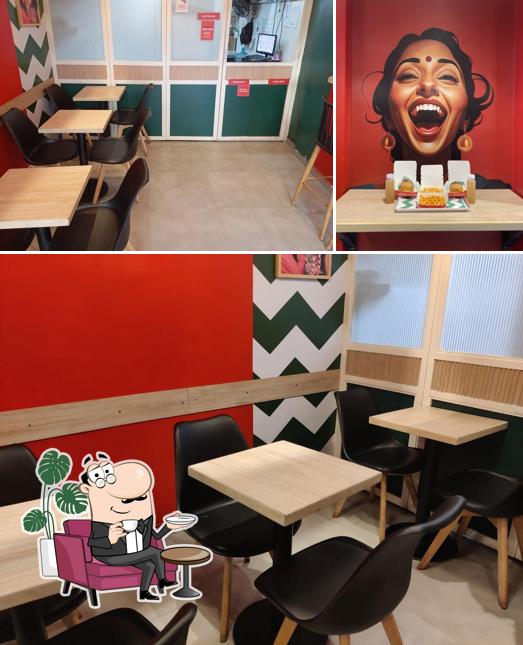 Take a seat at one of the tables at KHA - Burgers, Fries, Fried Chicken