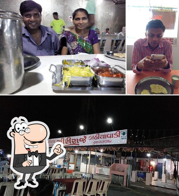 Take a seat at one of the tables at Hotel Giriraj Kathiyawadi