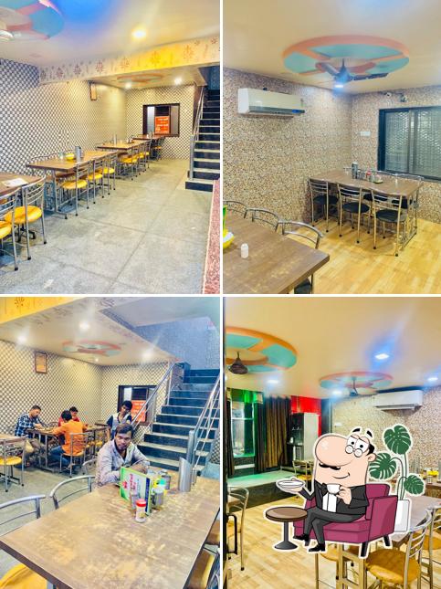 Take a seat at one of the tables at SHRI DURGA RAJASTHANI RESTAURANT