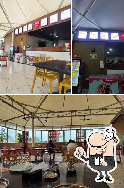 Take a seat at one of the tables at Jogeshwari Misal,Vadgoan Mawal