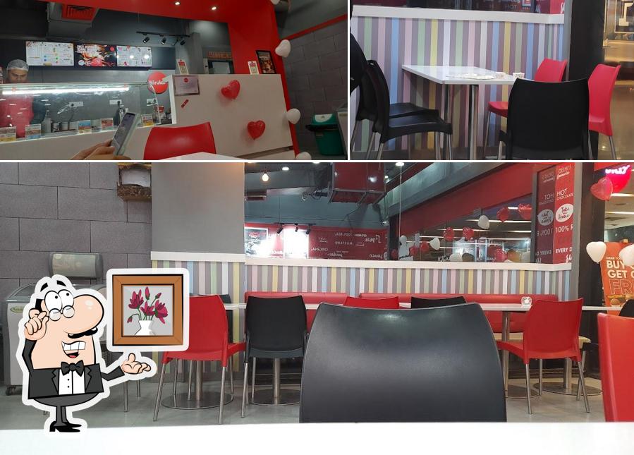 Take a seat at one of the tables at Nirula's Cross River Mall