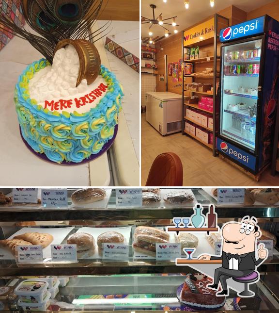 Take a look at the picture depicting interior and food at Winni Cakes & More ( Madhuvan Cafe )