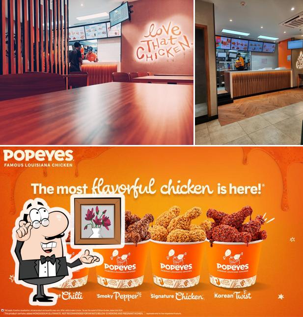 Take a look at the picture depicting interior and food at Popeyes - Famous Louisiana Chicken