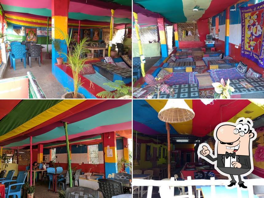 Take a seat at one of the tables at Hampi Roof Restaurant