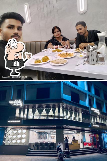 Take a seat at one of the tables at Cafe Ashirwad - 3