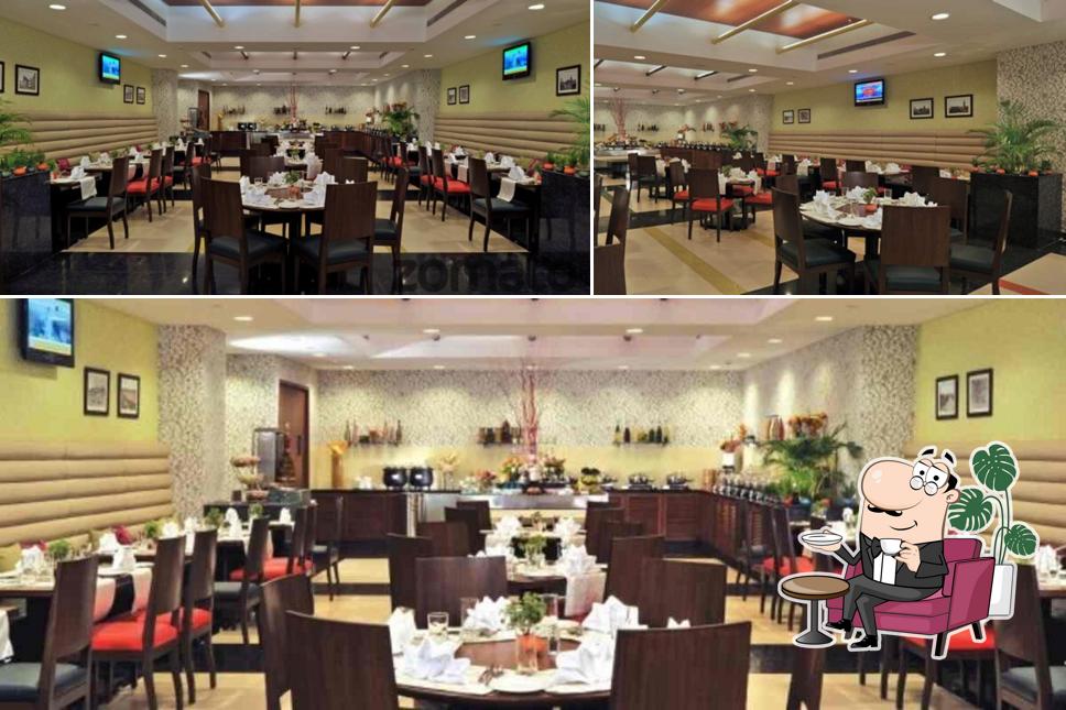 Take a seat at one of the tables at Rainbow Exclusively Veg Restaurant