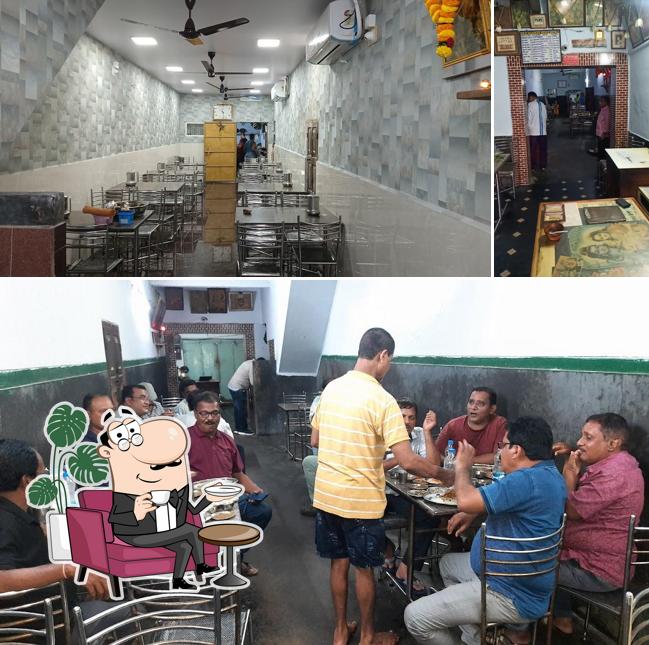 Take a seat at one of the tables at Devi Shankar meals Hotel